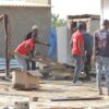 Angry community members looting the tavern of the suspected killer before burning it down. Photo by Tumelo Mofokeng