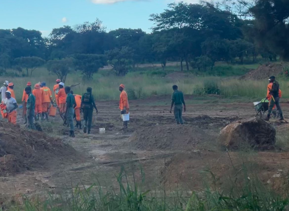 Prisoners under armed guard working on the perimeter wall of the Warren Hills Golf Course development, raising questions about the legality and ethics of using prison labor for private projects.